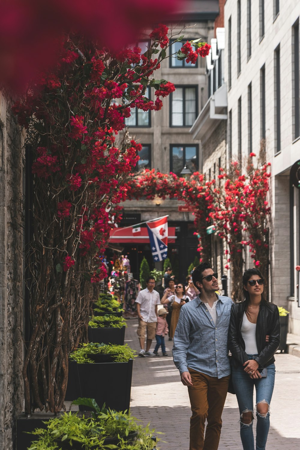 man and woman walking on sidewalk