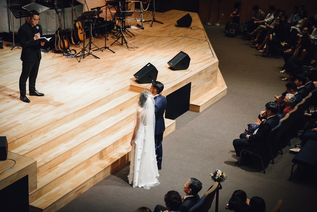 bride and groom standing near stage