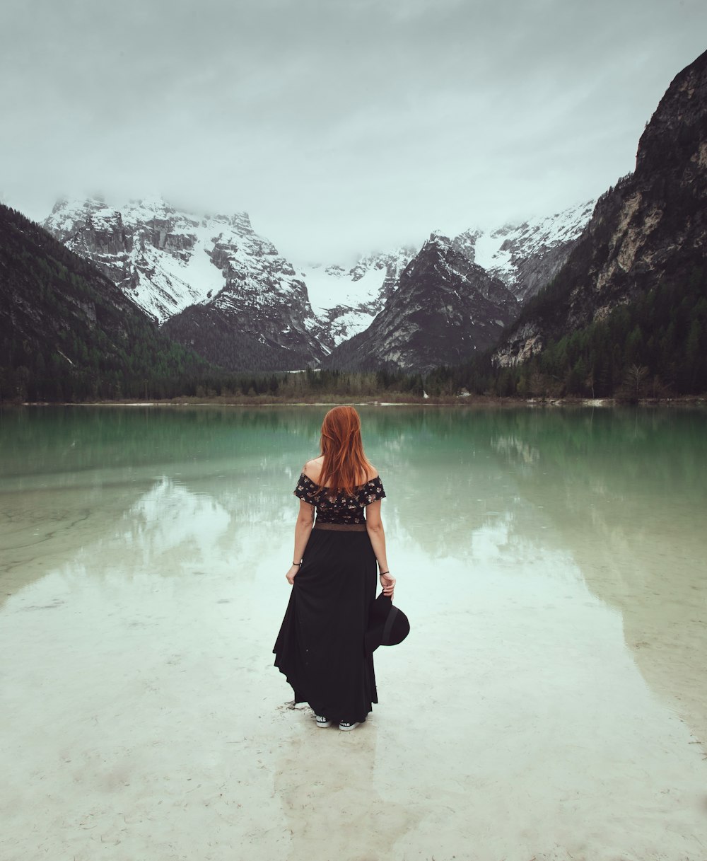 woman standing on shore during daytime