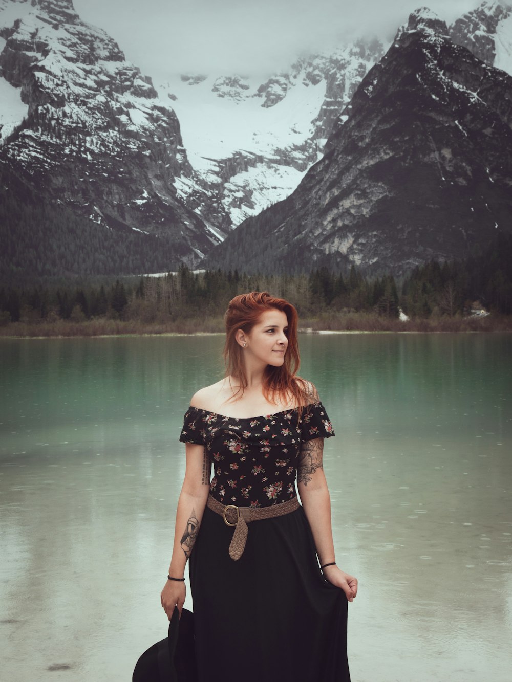 woman wearing black and red floral off-shoulder blouse and black skirt