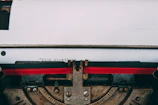 Close-up of a vintage typewriter with a sheet of poetry in progress.
