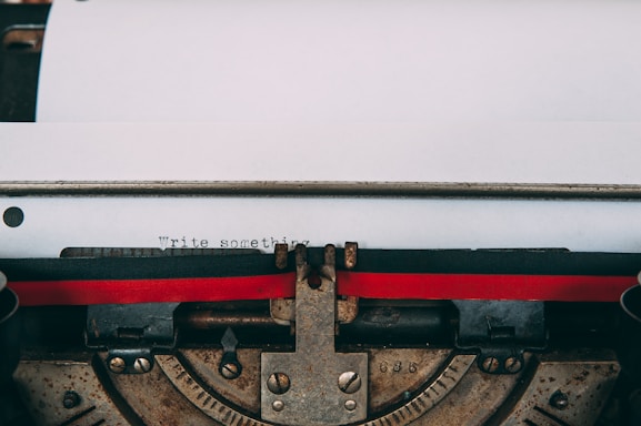 A close-up of a vintage typewriter with a sheet of paper titled 'Contact' in bold letters.