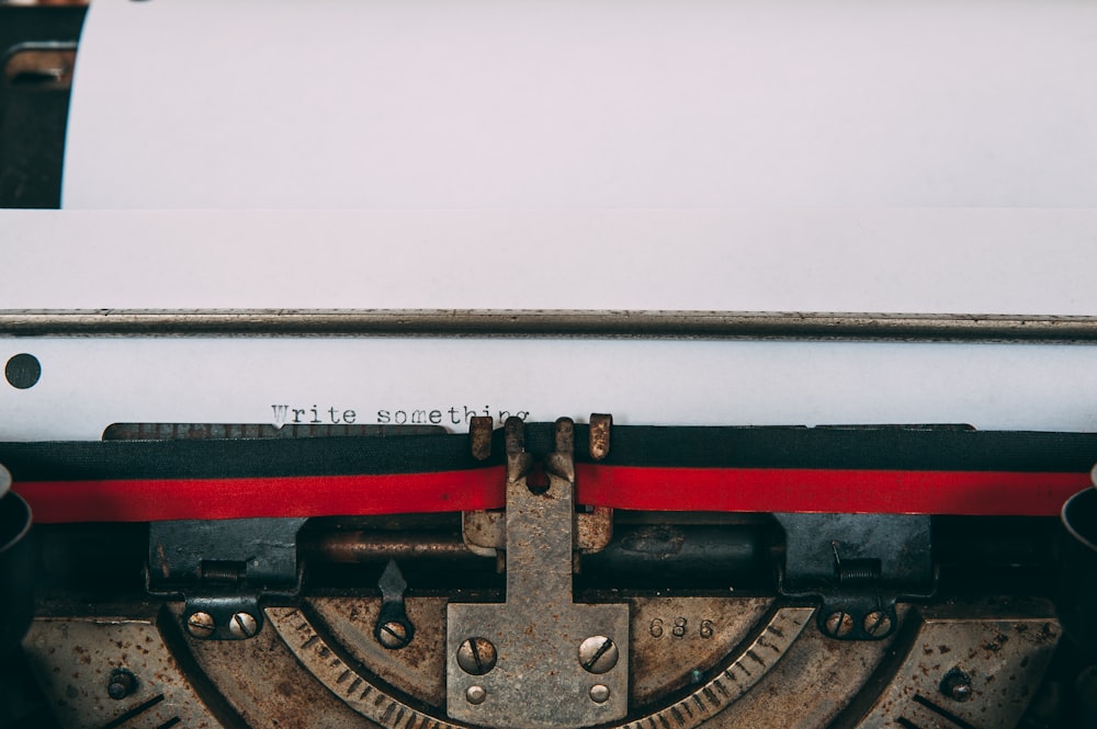 typewriter with paper displaying write something text