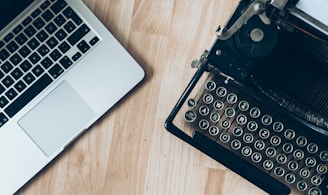 MacBook beside typewriter machine