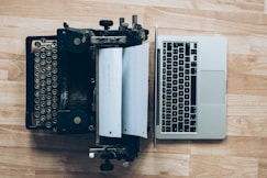 gray typewriter and MacBook