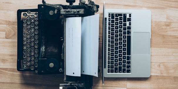 gray typewriter and MacBook