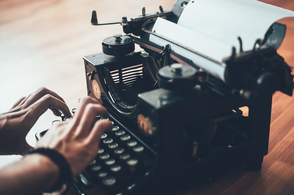 person using typewriter