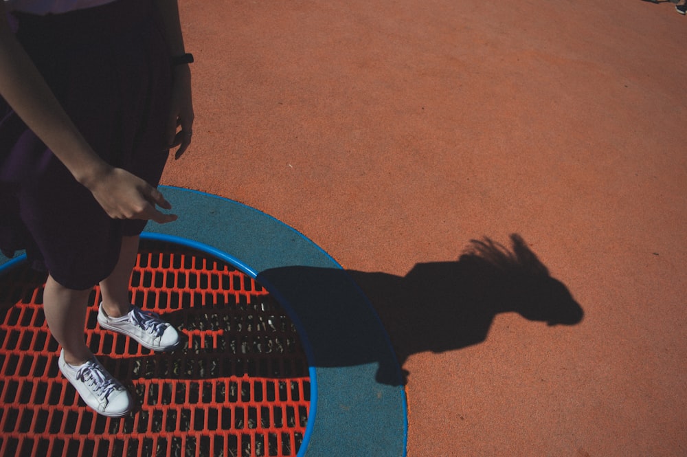 man standing on orange pavement