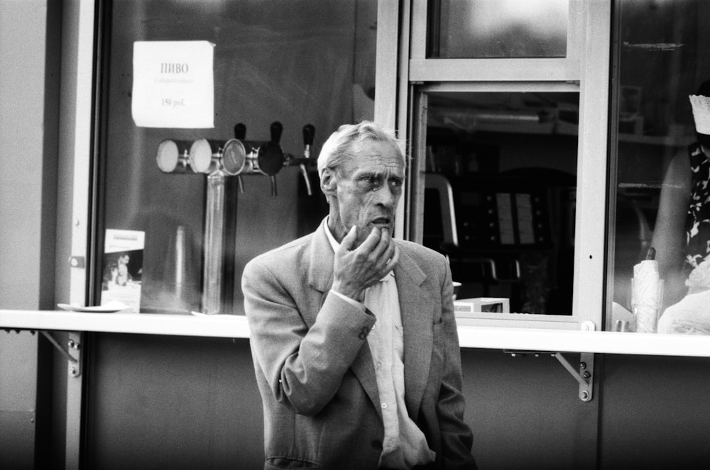 grayscale photo of man in suit jacket