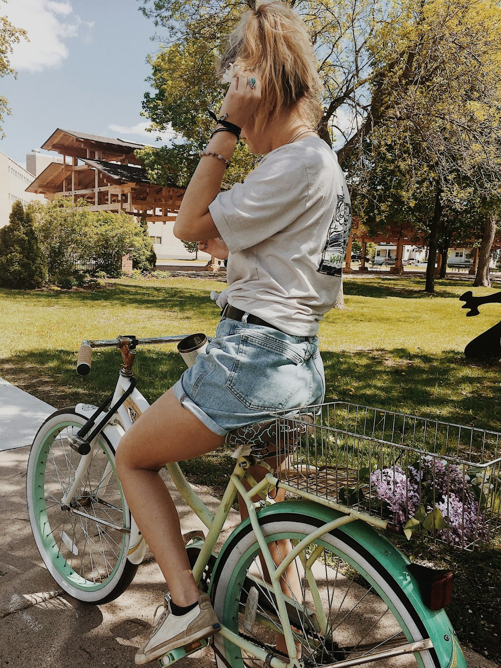 man riding white and green cruiser bike