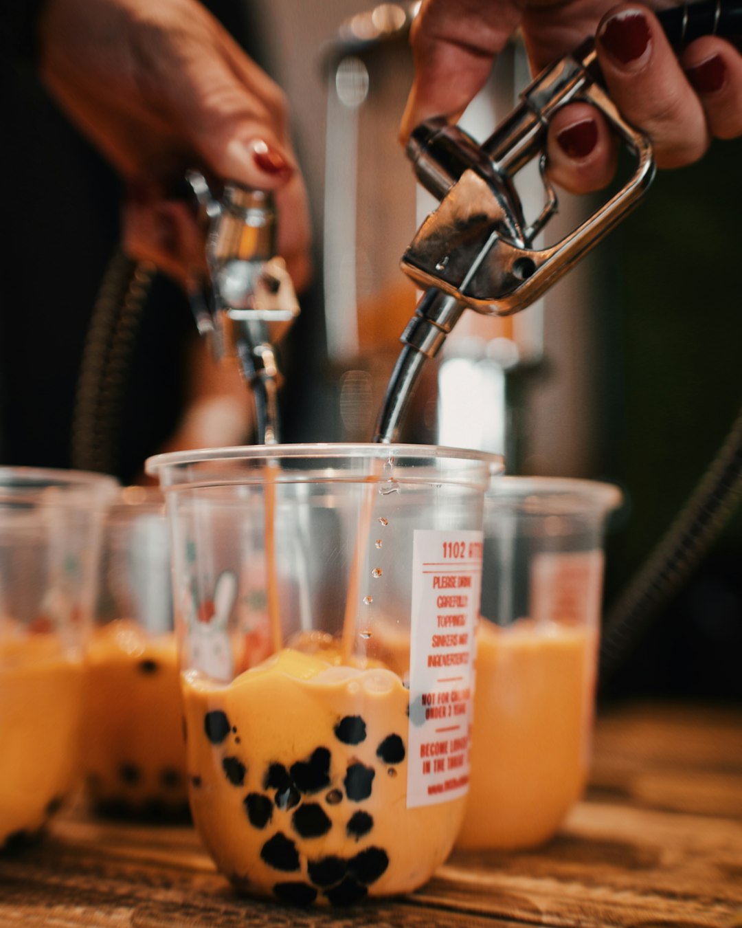 person pouring liquid to container