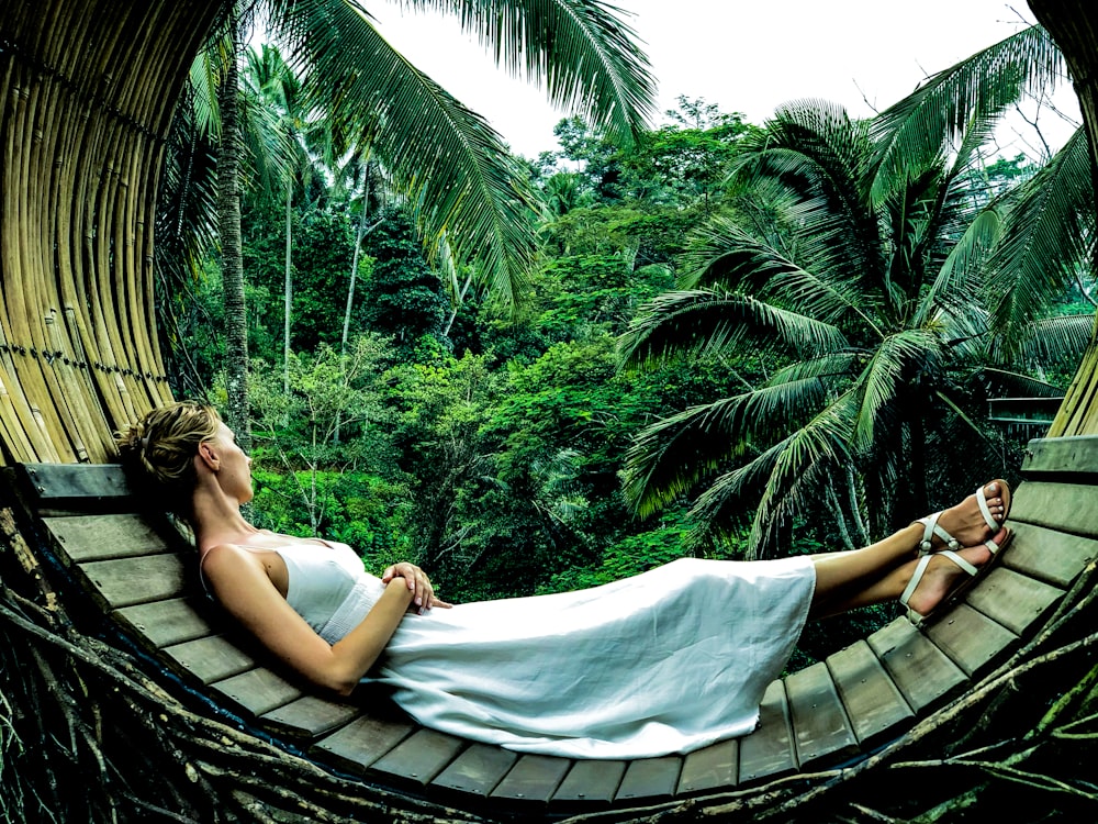 woman wearing white dress lying on brown surface