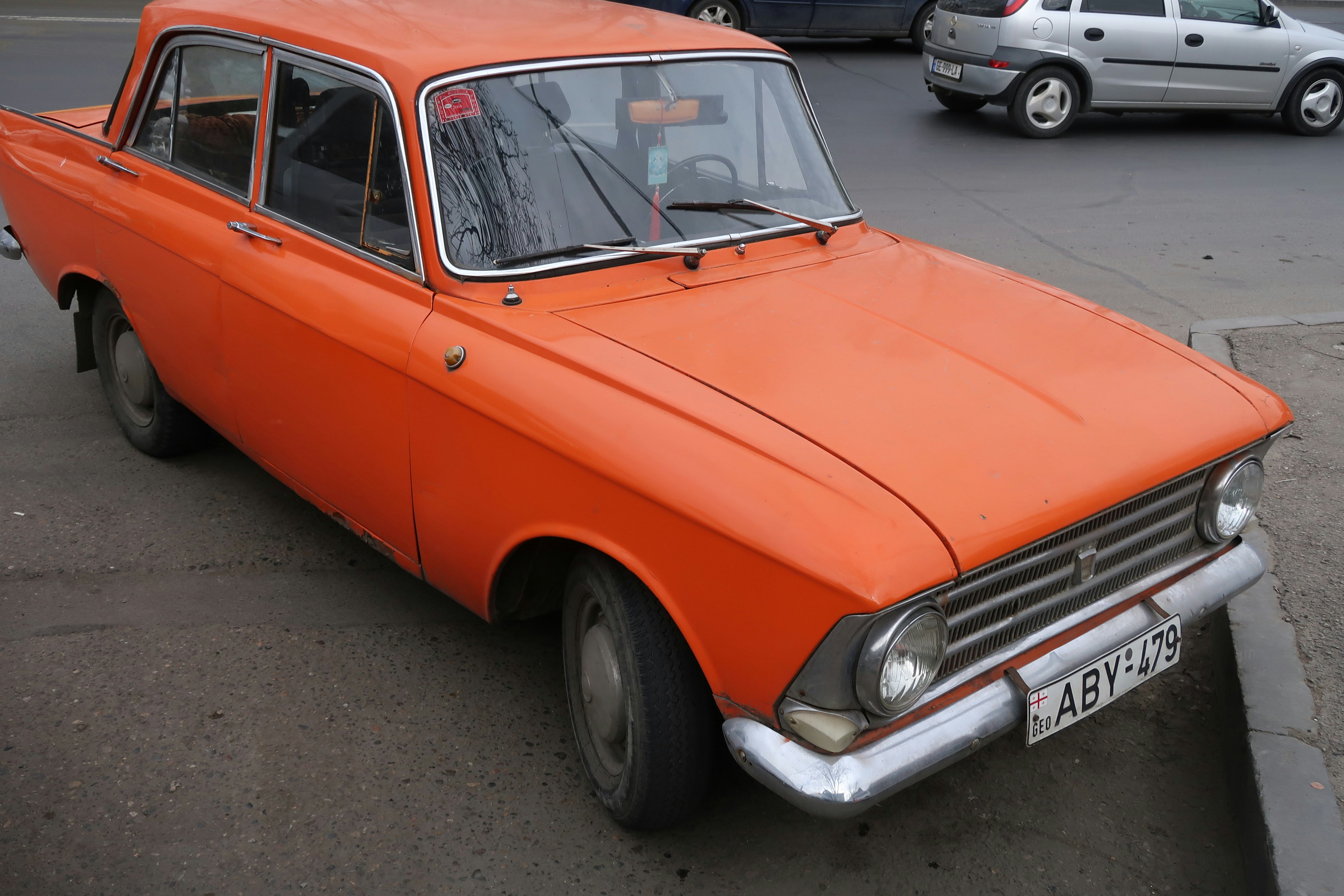 parked orange sedan