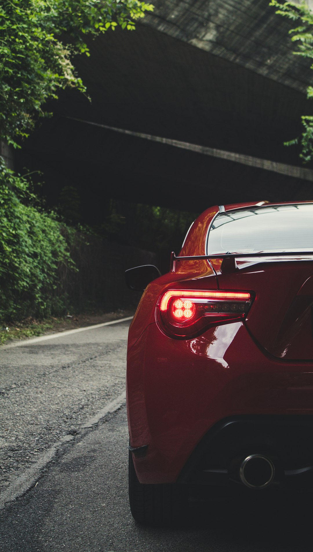 red vehicle on focus photography