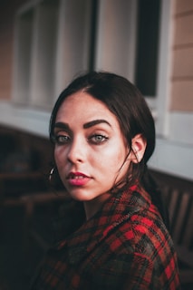 woman near white and brown wall