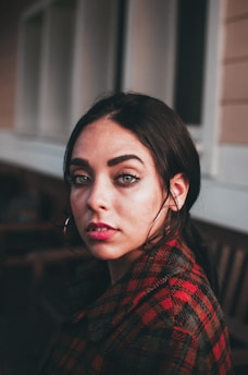 woman near white and brown wall