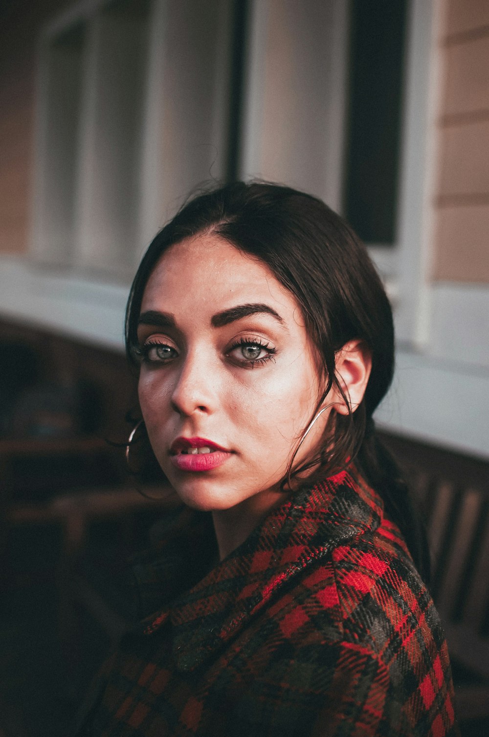 woman near white and brown wall