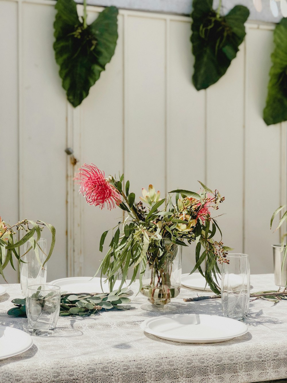 red-petaled flower on center table