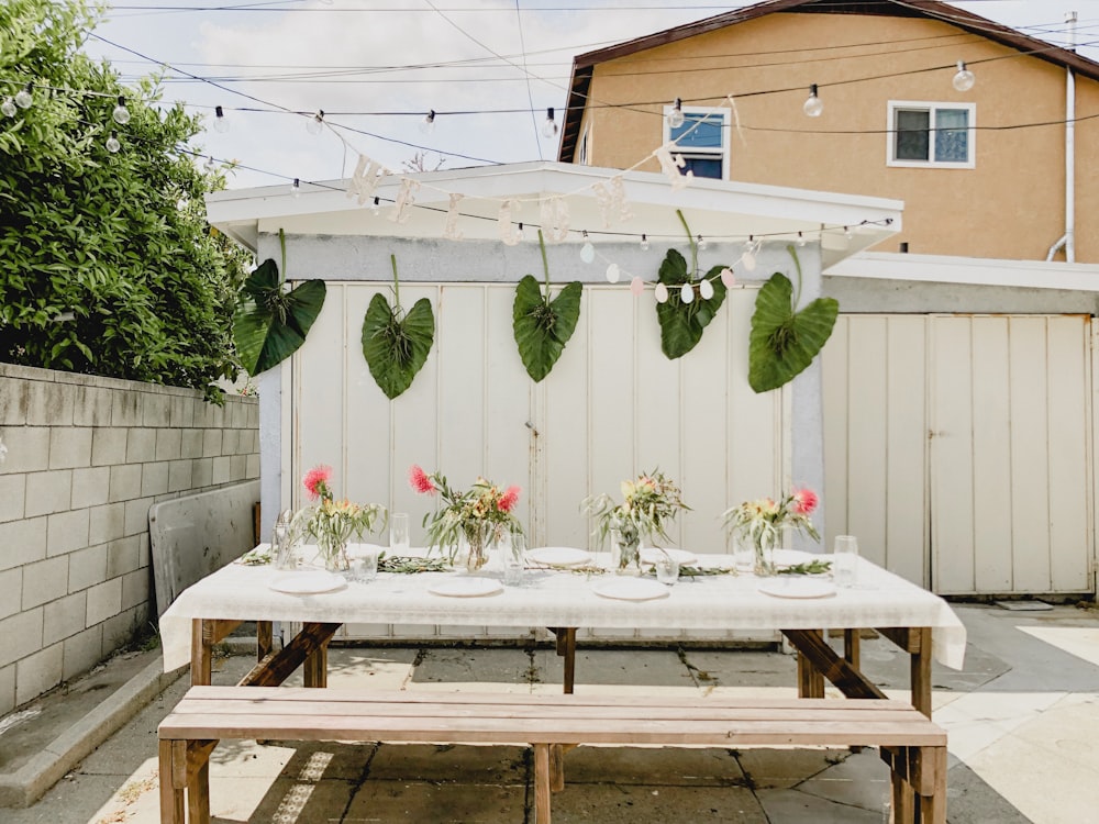 empty picnic table with plates and flowers