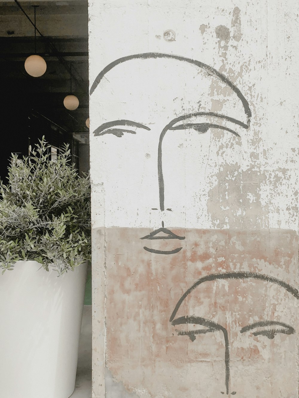 human face sketch in wall close-up photography