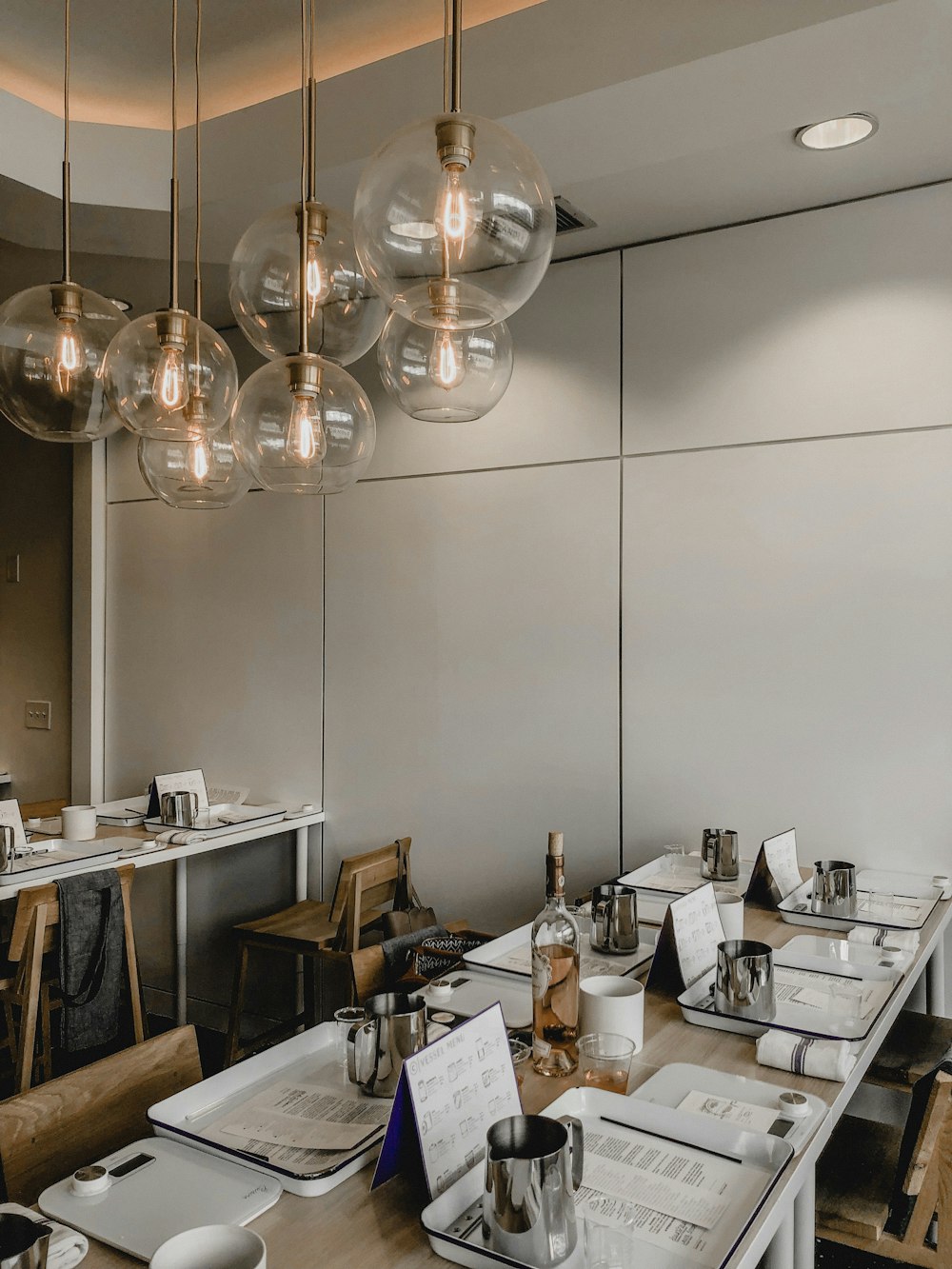 gray stainless steel mugs on white trays on table