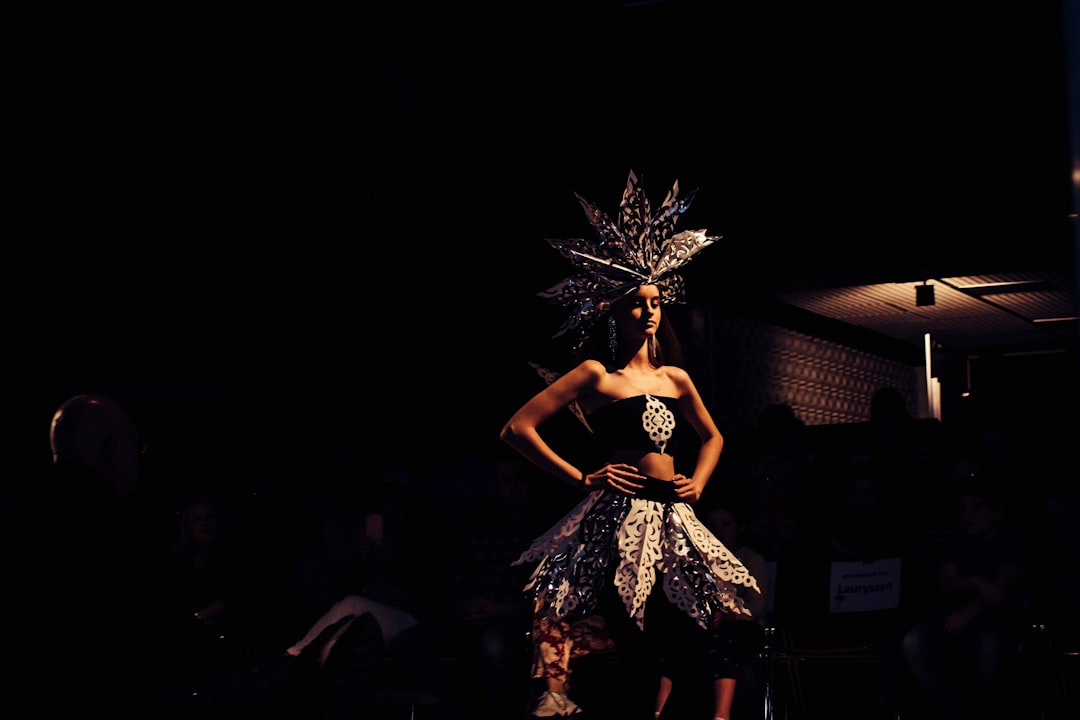 standing woman wearing gray and black dress with headdresses