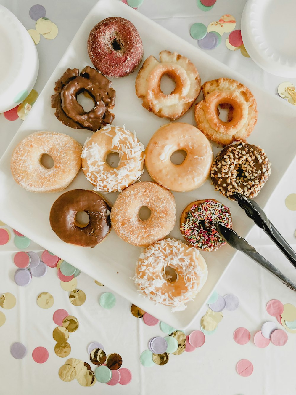 assorted doughnuts on white ceramic tray