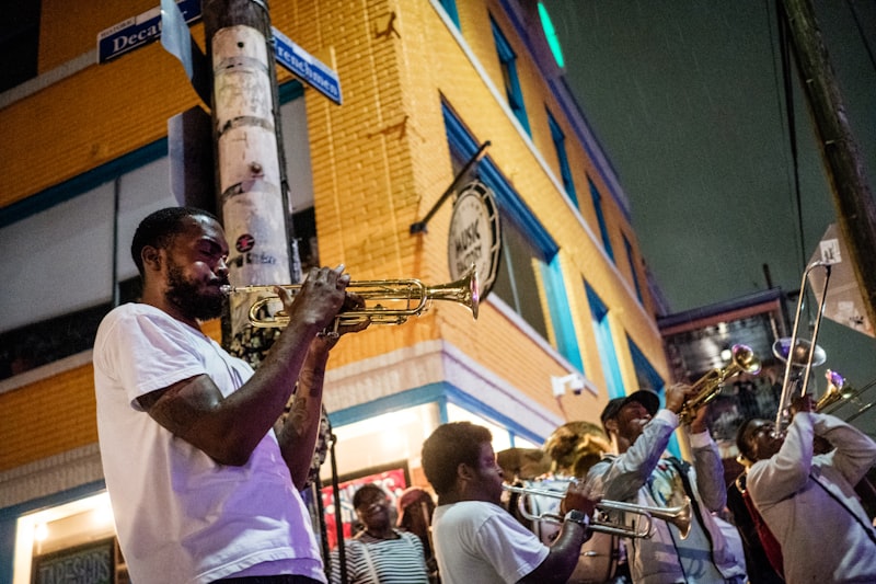 Man playing trumpet on a New Orleans street at night