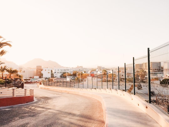 concrete road with no vehicle near high-rise buildings in Cabo San Lucas Mexico