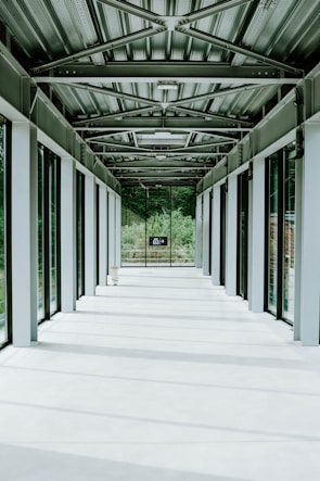 Wide shot of a hospital corridor with natural light highlighting clean, contemporary design.