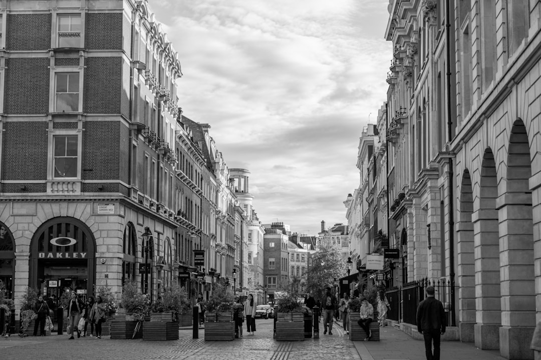 grayscale photo of people in square,