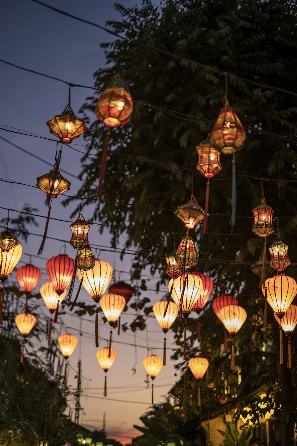 lighted lantern hanging over street