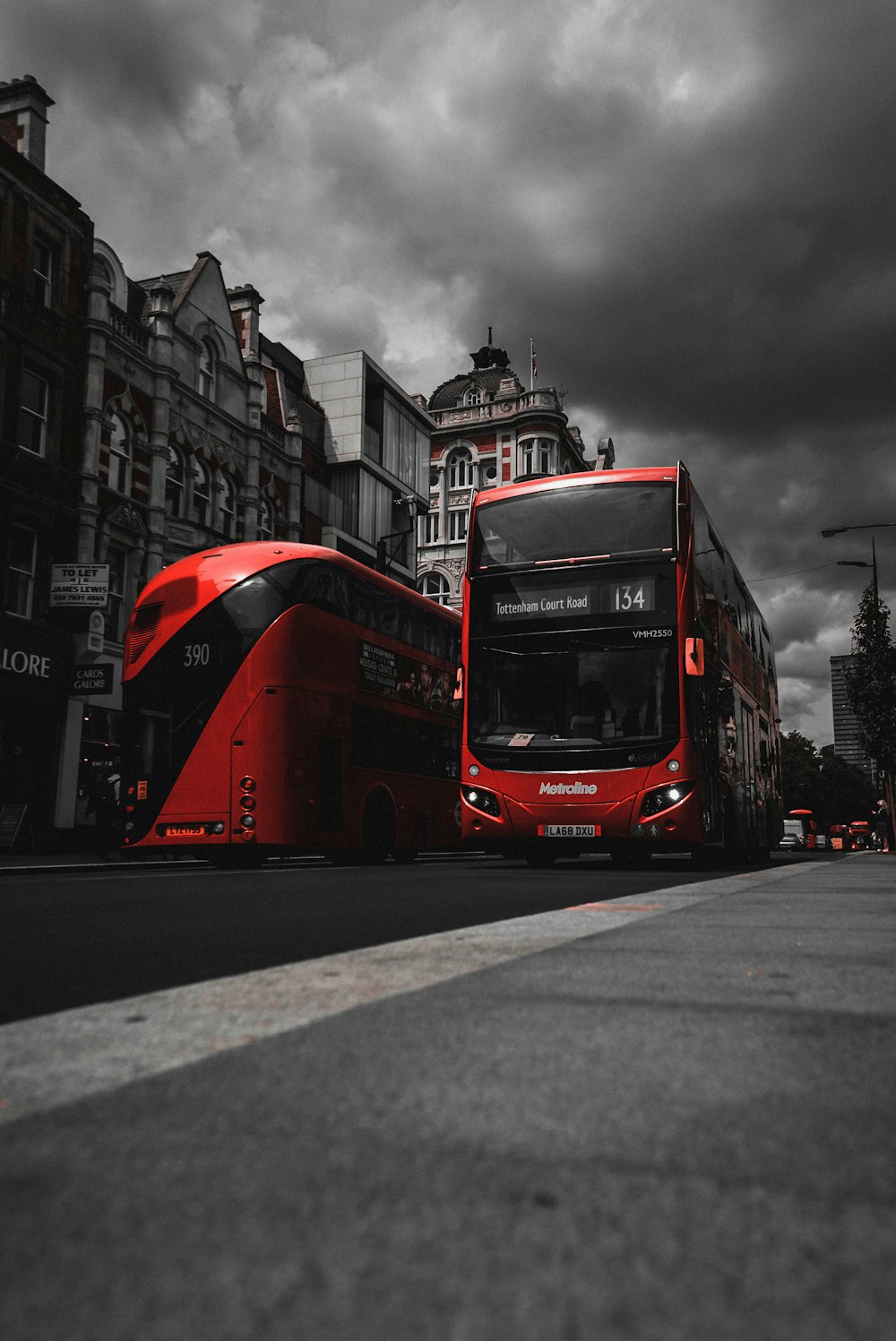 red and black bus on road near concrete buildings