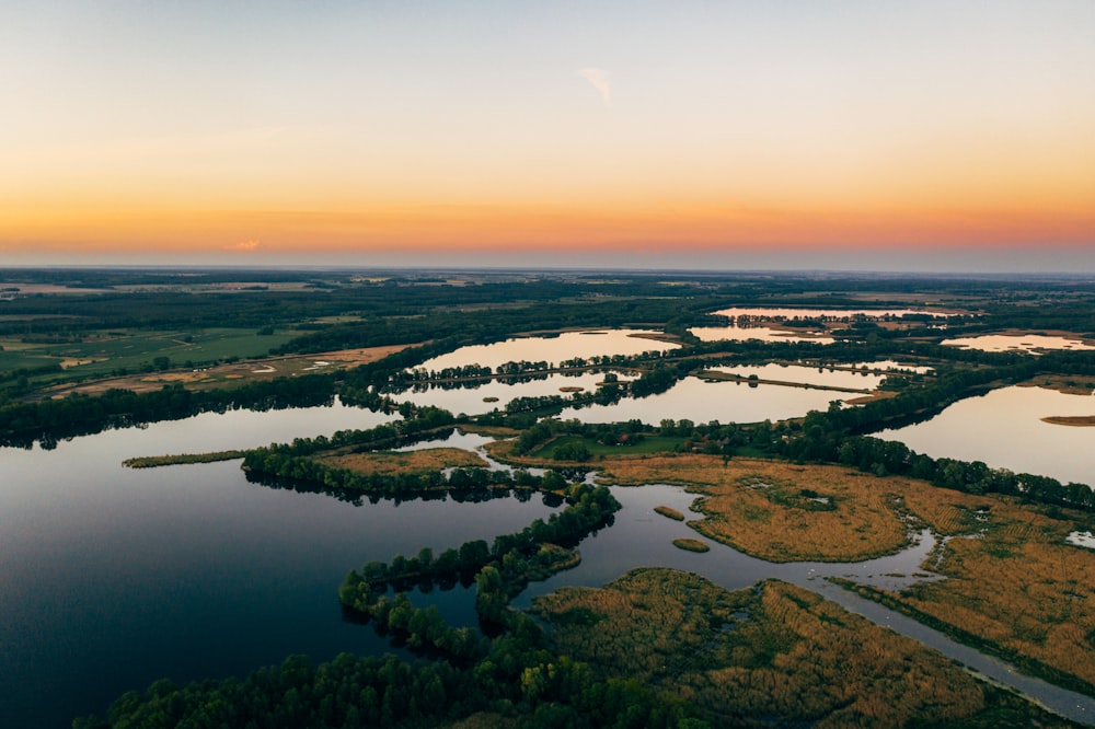 high angle photography of body of water near forest