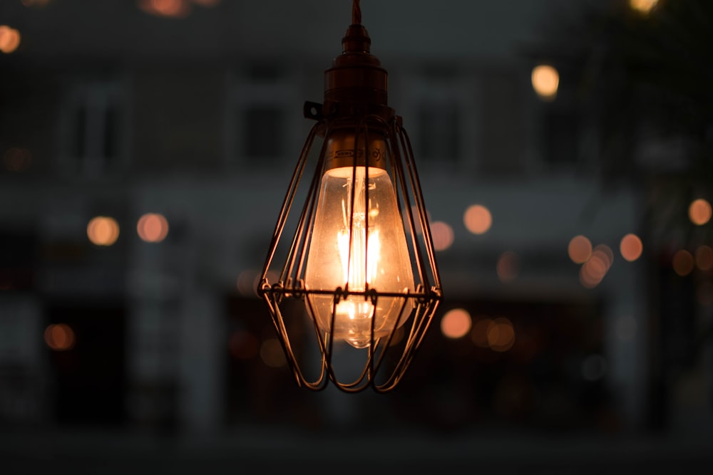 brass-color framed pendant lamp in selective focus photo