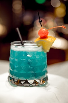 Close-up of a crystal clear ice glass filled with a vibrant cocktail.