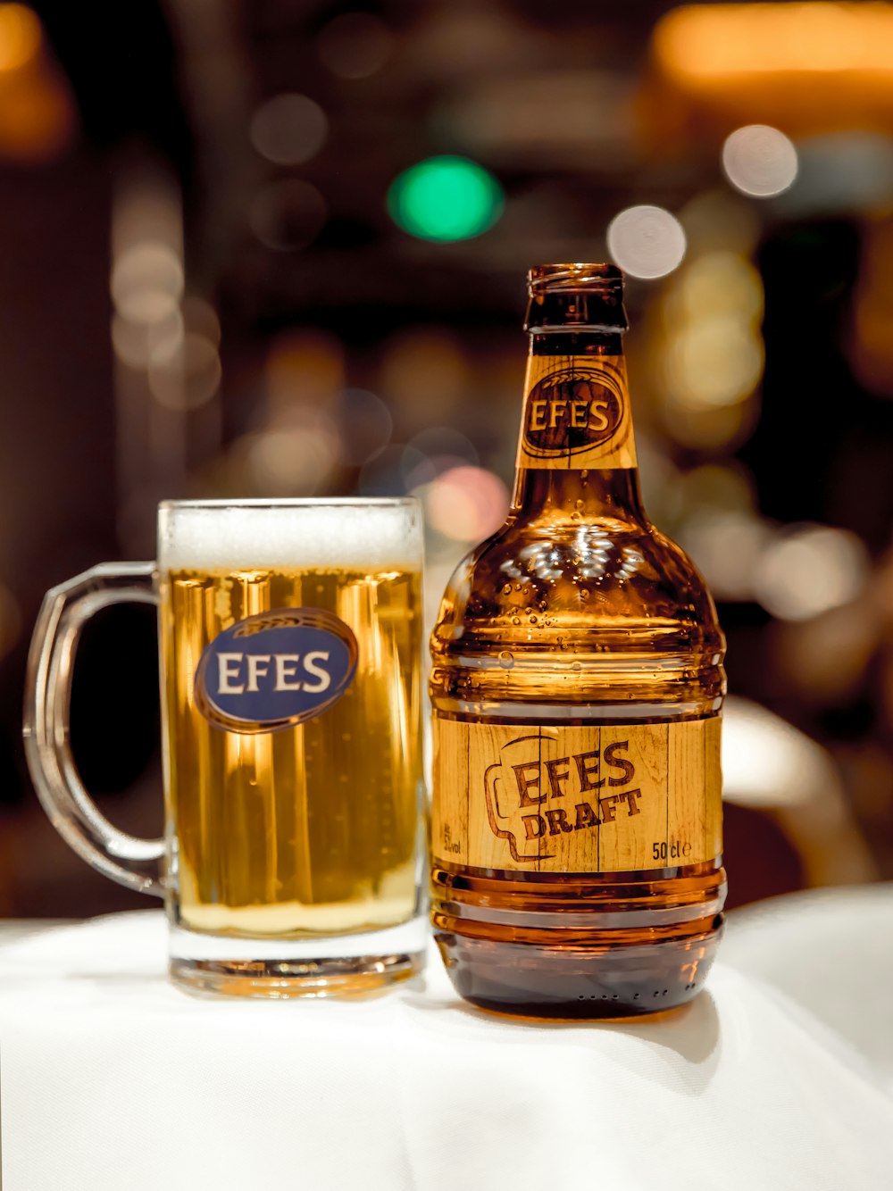 Efes Draft bottle near glass of beer