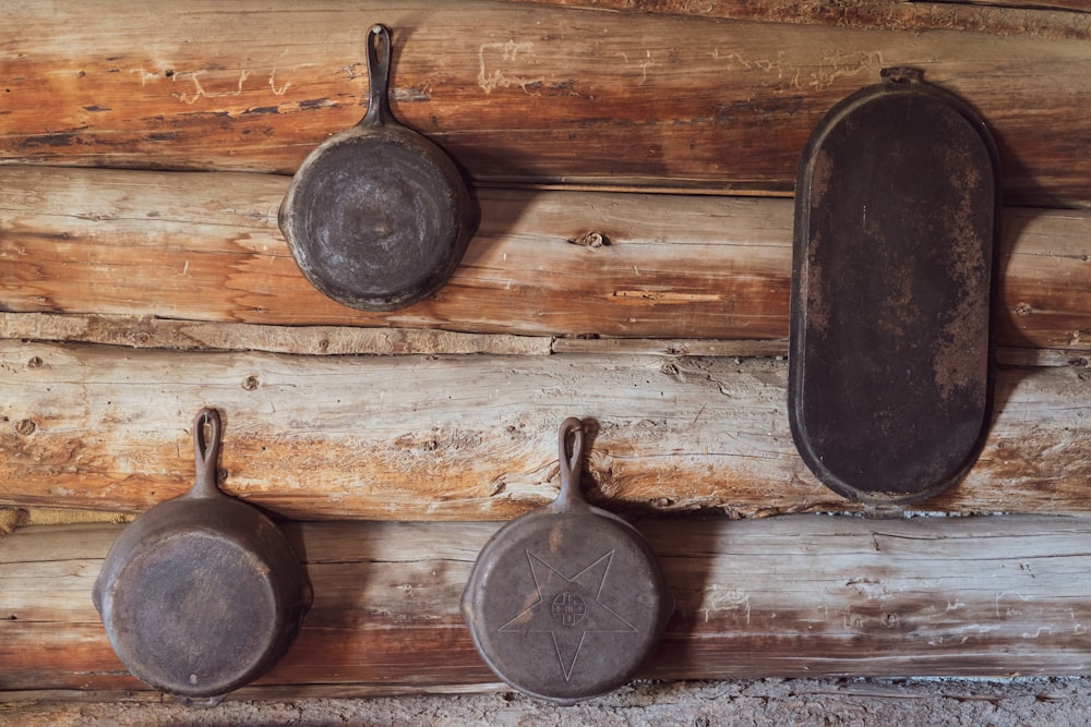 three gray cast iron skillets