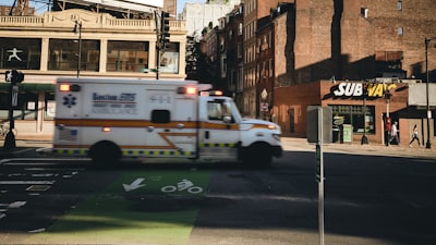white ambulance near building