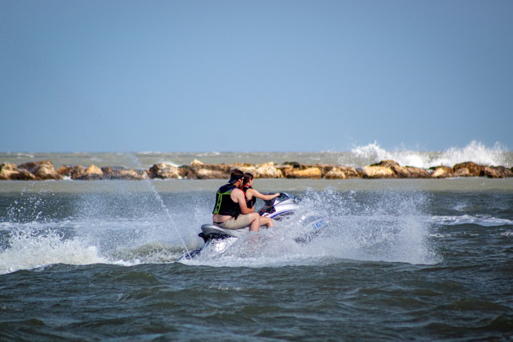 a man riding a jet ski on top of a body of water