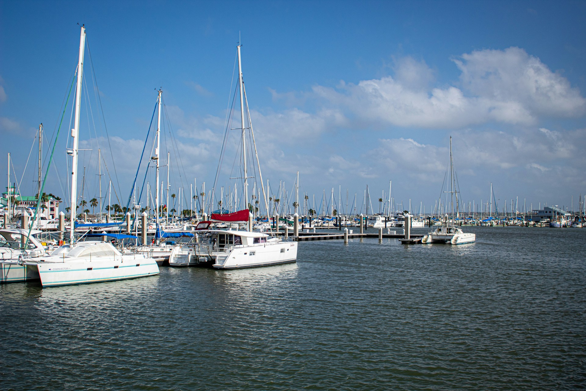 a harbor filled with lots of boats under a blue sky