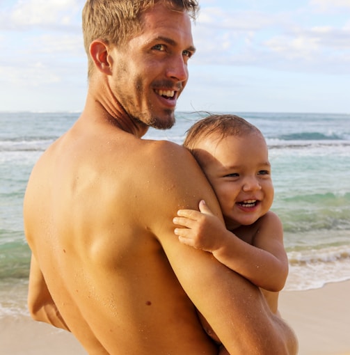 man carrying baby