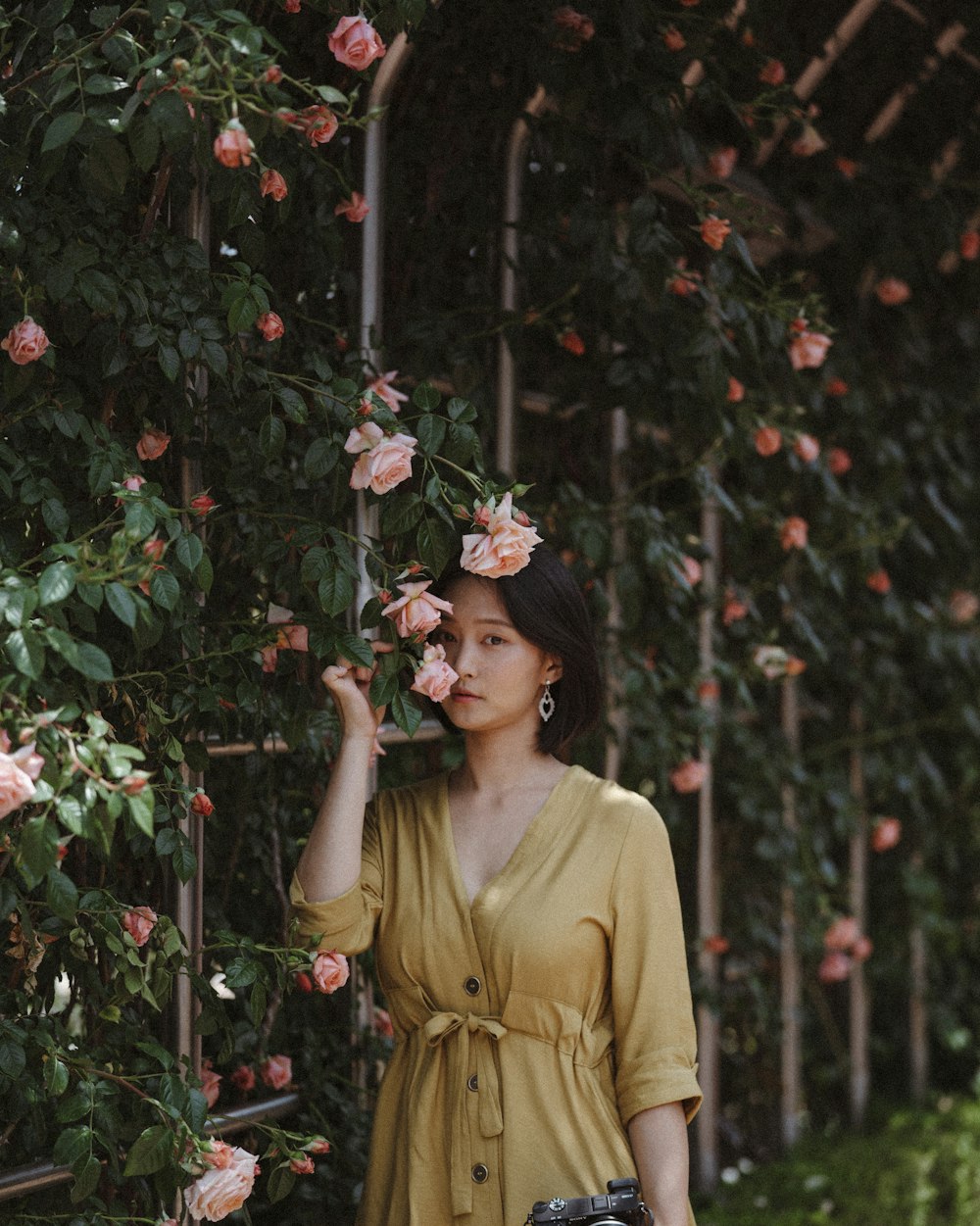 mujer de pie junto a la planta de la flor