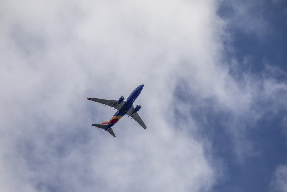 low angle photography of blue and white airplane