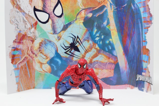 A dynamic close-up of a Spider-Man inspired portfolio layout featuring bold red, blue, and black color blocks.