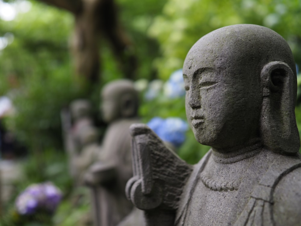 concrete statues near trees