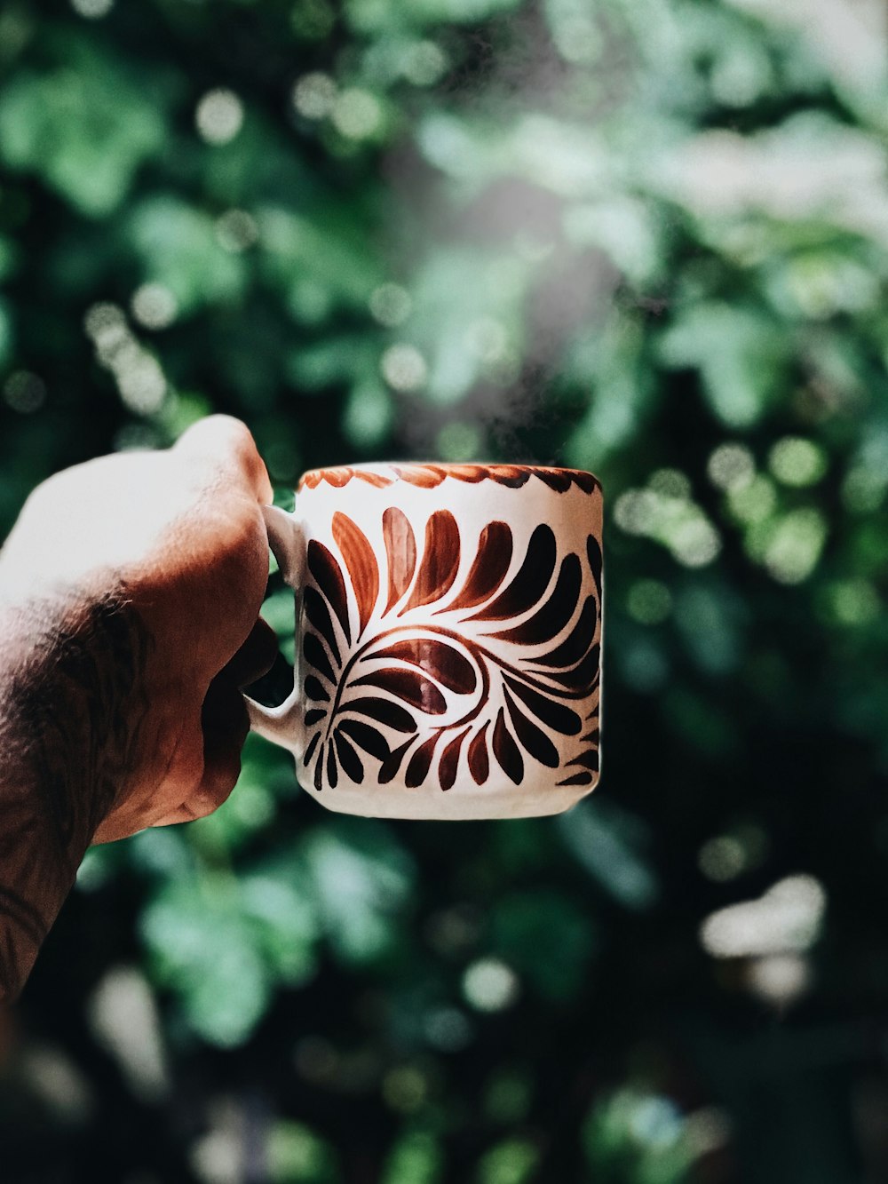 white and brown ceramic mug