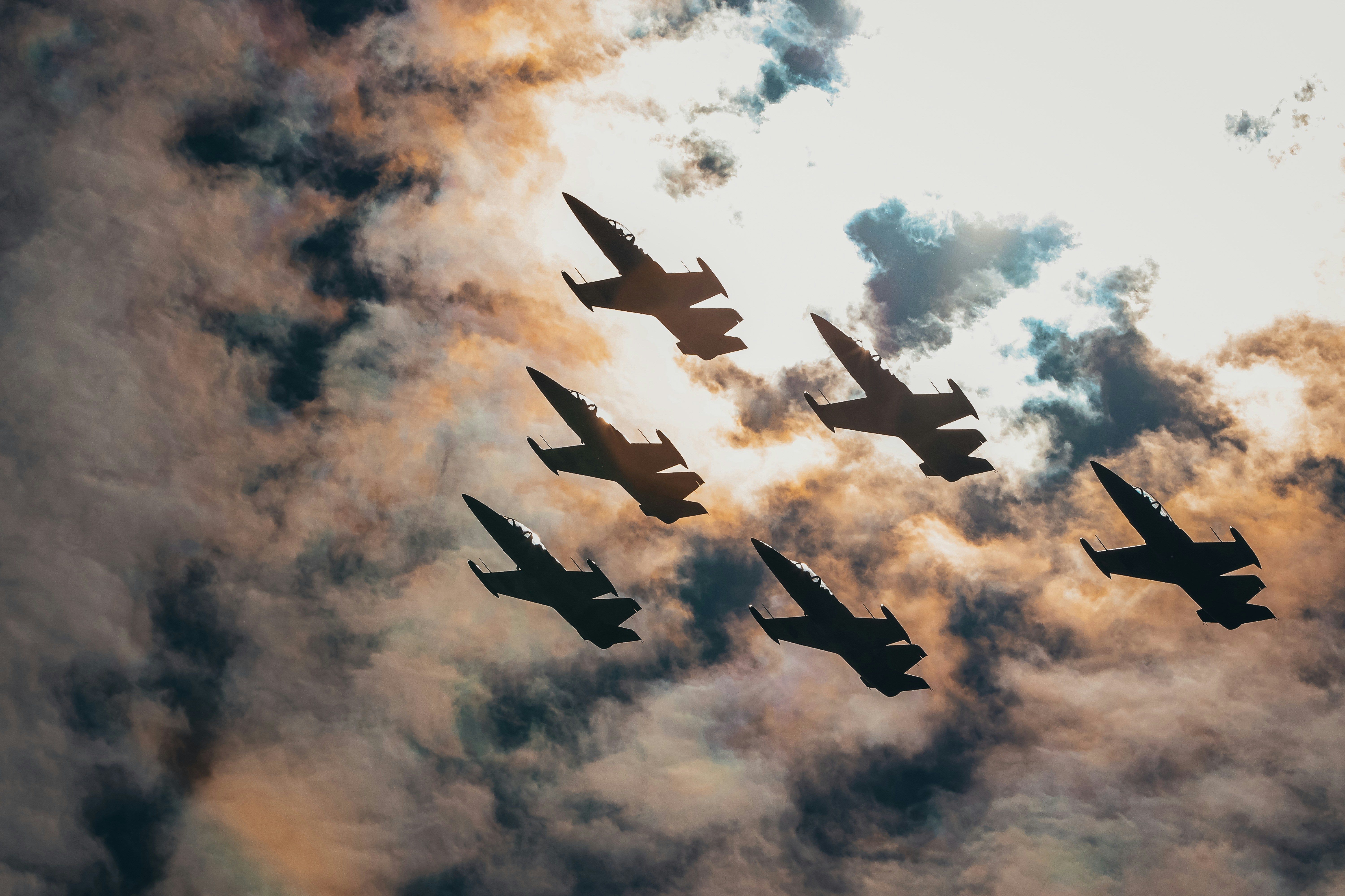 six fighter plane under orange and white skies, 