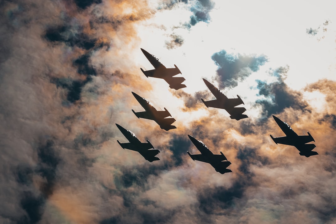 six fighter plane under orange and white skies,
