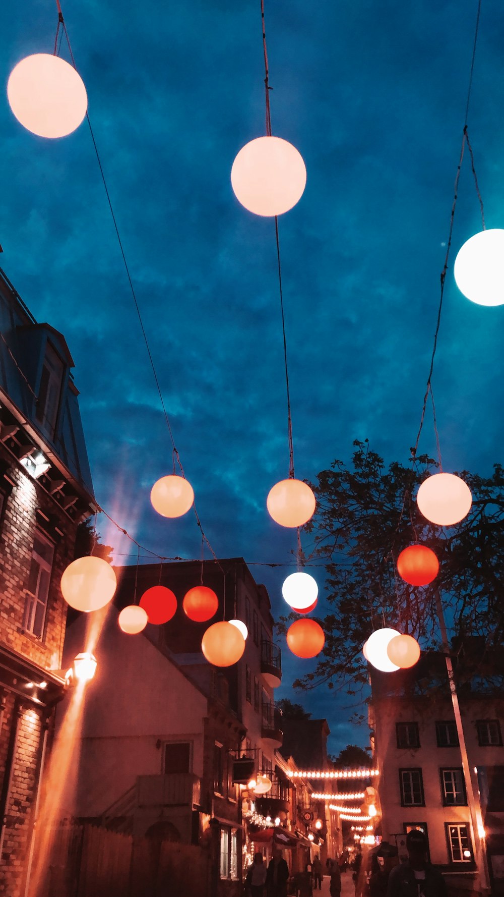lighted multicolored lanterns hanging over street